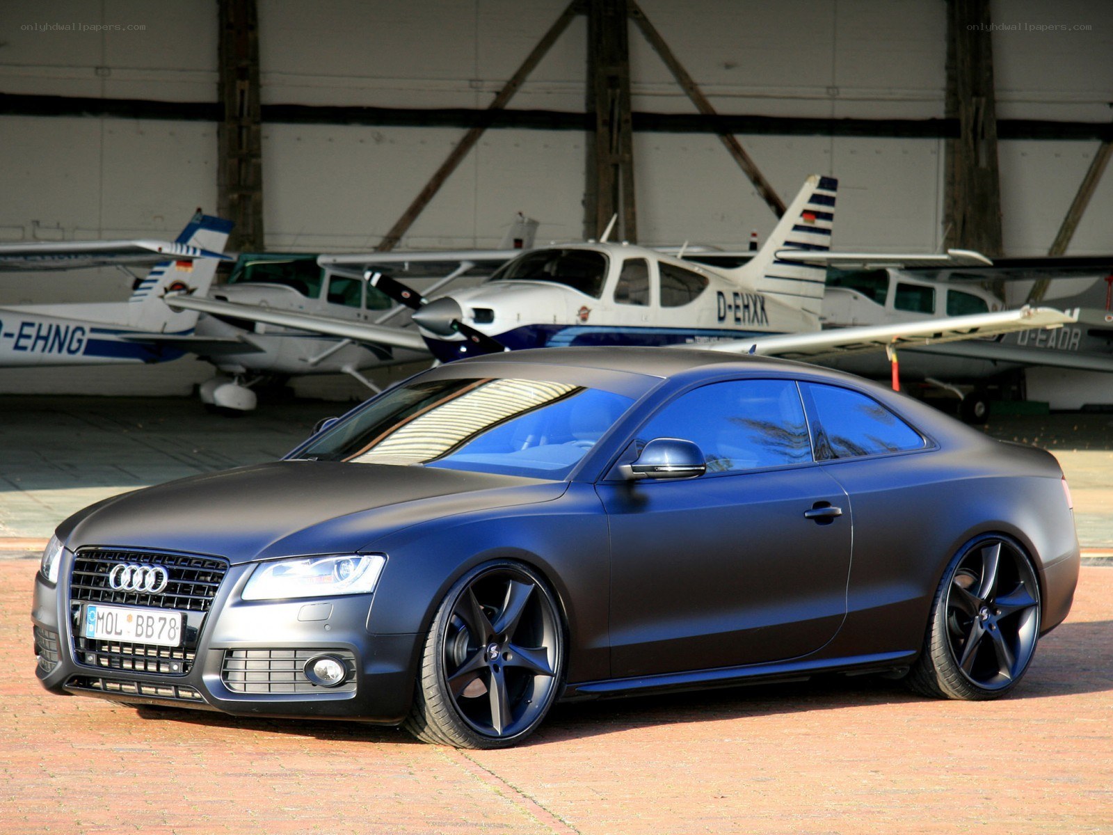 Matte black Audi in hangar