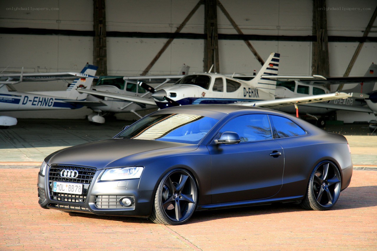 Matte black Audi in hangar