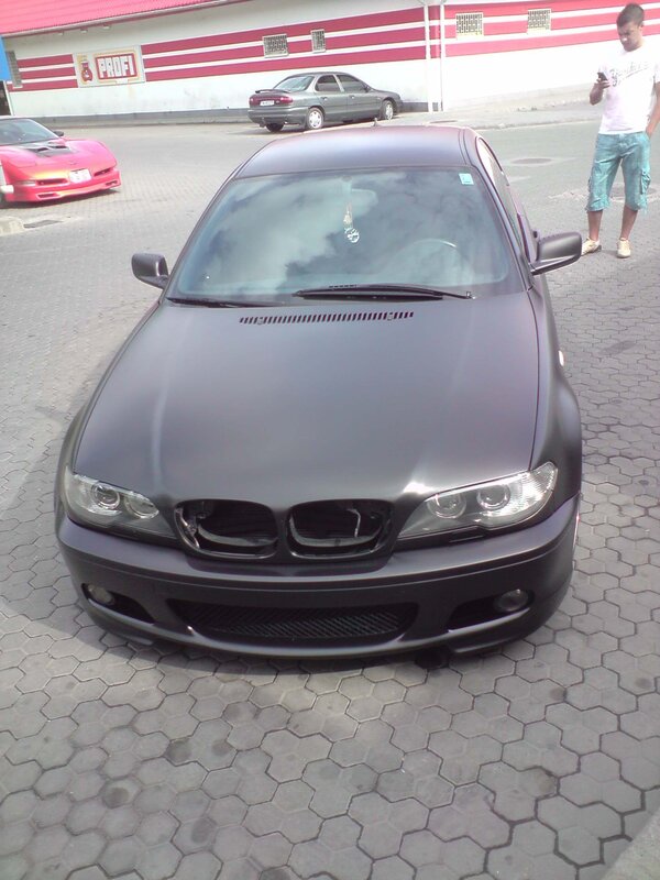 matte black bmw in parking lot