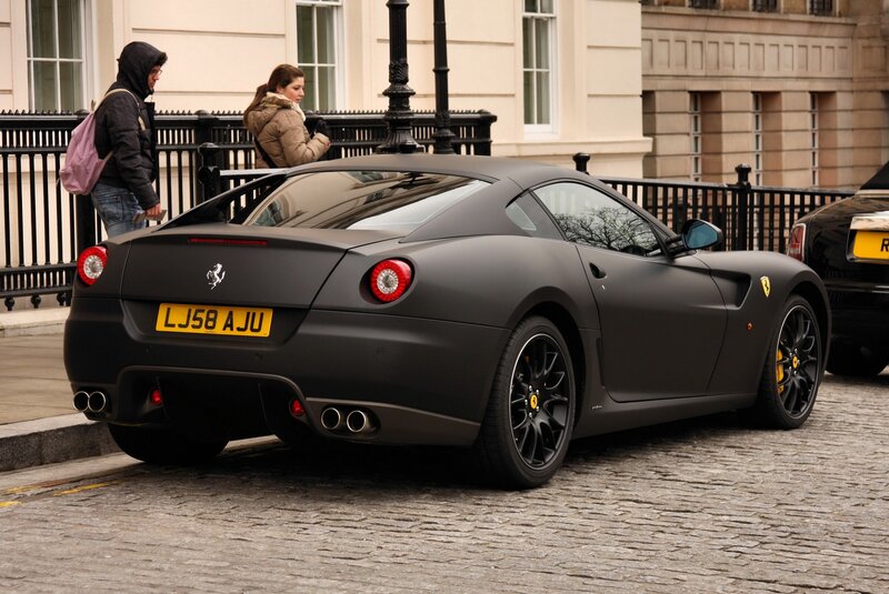 Matte black Ferrari on cobblestones