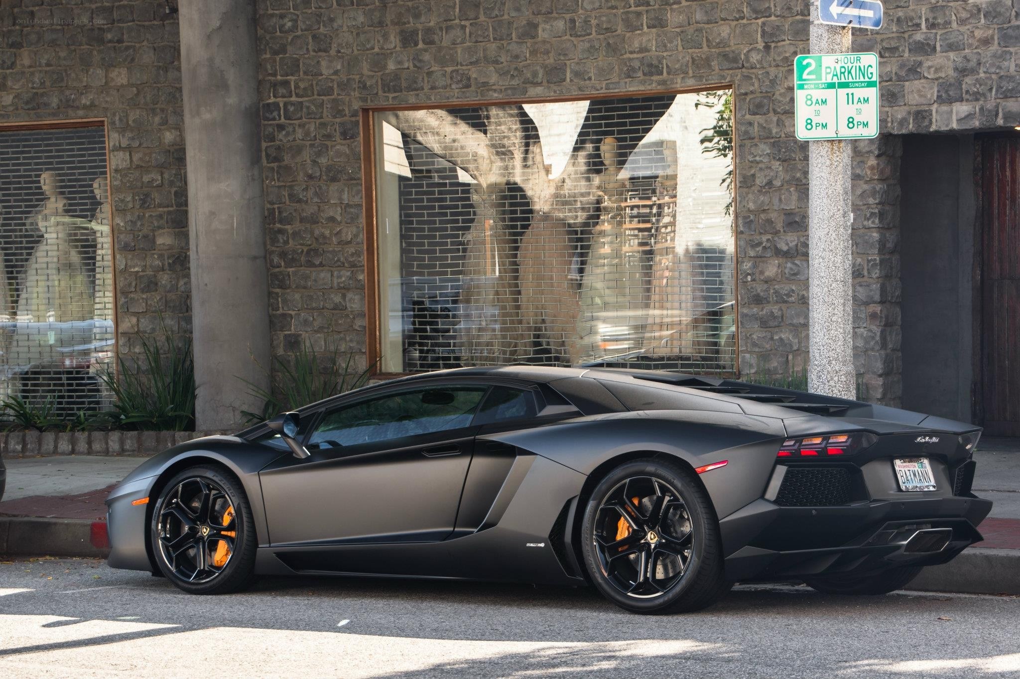 Matte black Lamborghini parked on street