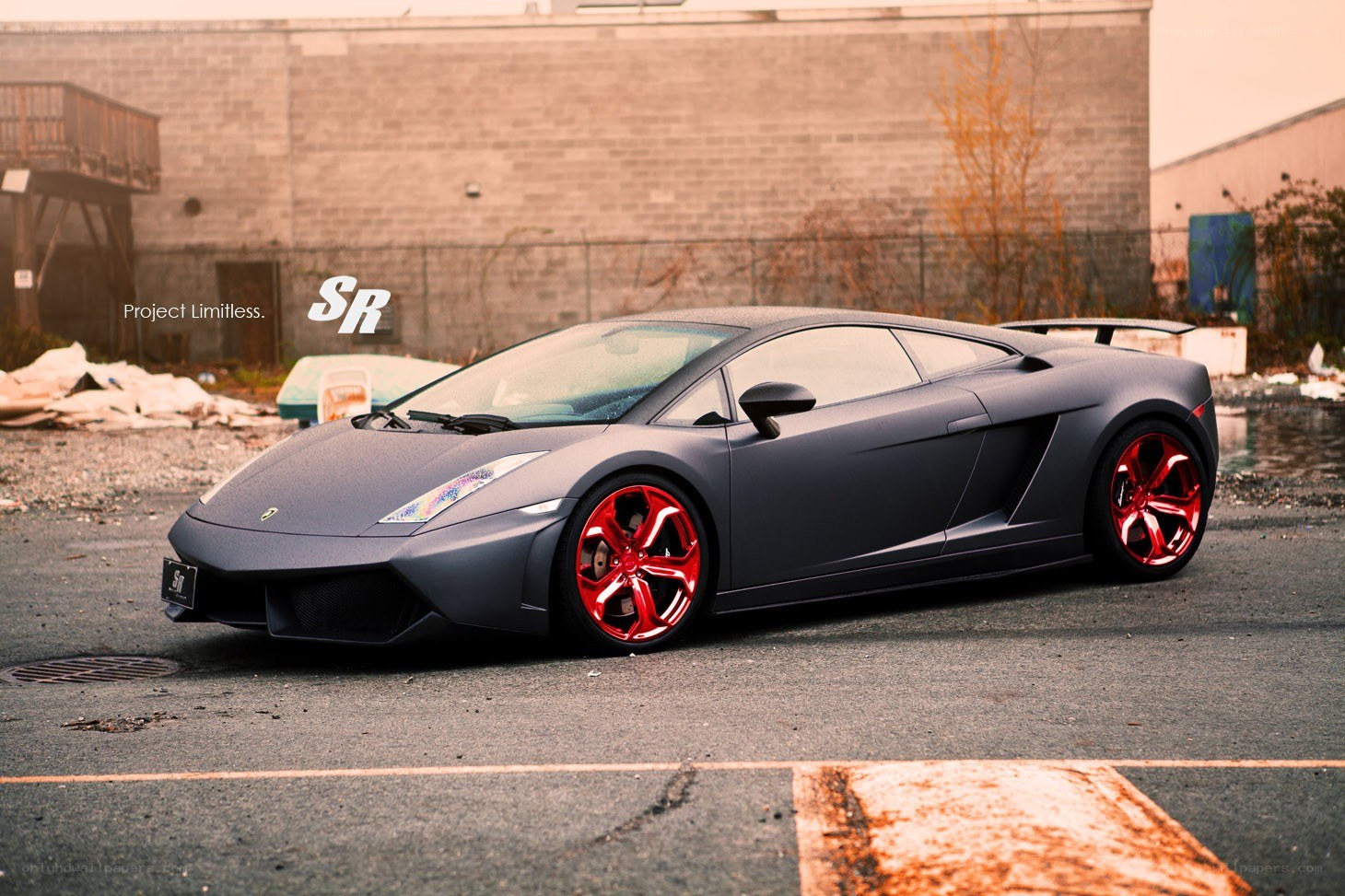 Matte black Lamborghini with red wheels