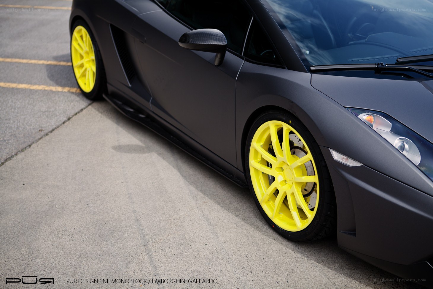 Matte black Lamborghini with yellow wheels