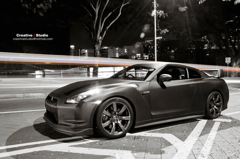 Matte black sports car at night