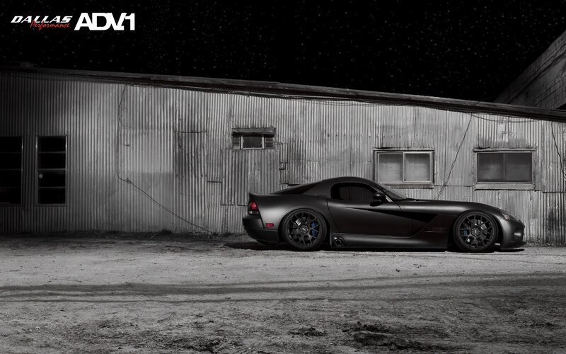 Matte black sports car at night