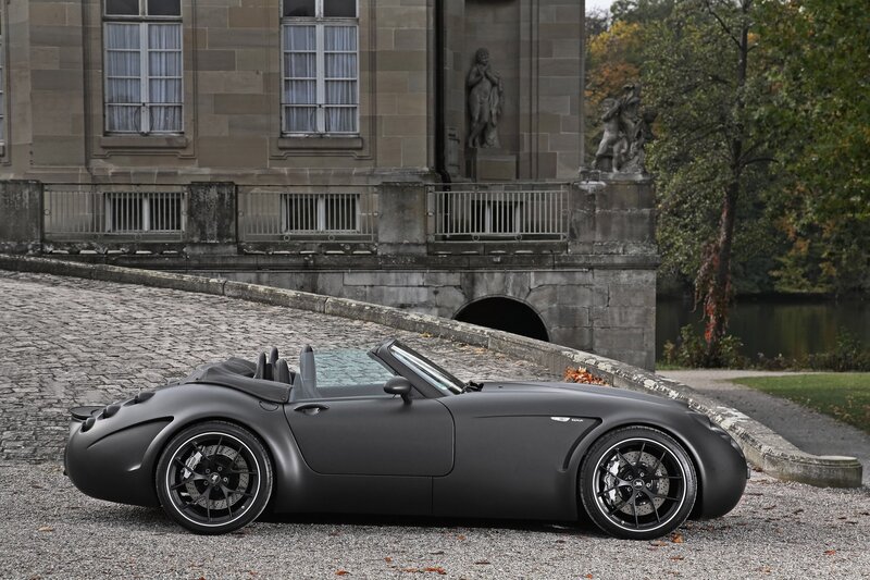 Matte black sports car on cobblestone