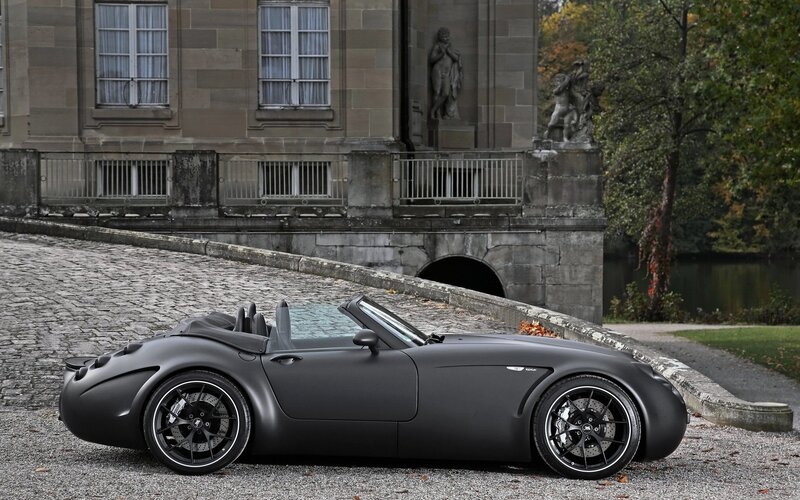 Matte black sports car on cobblestones