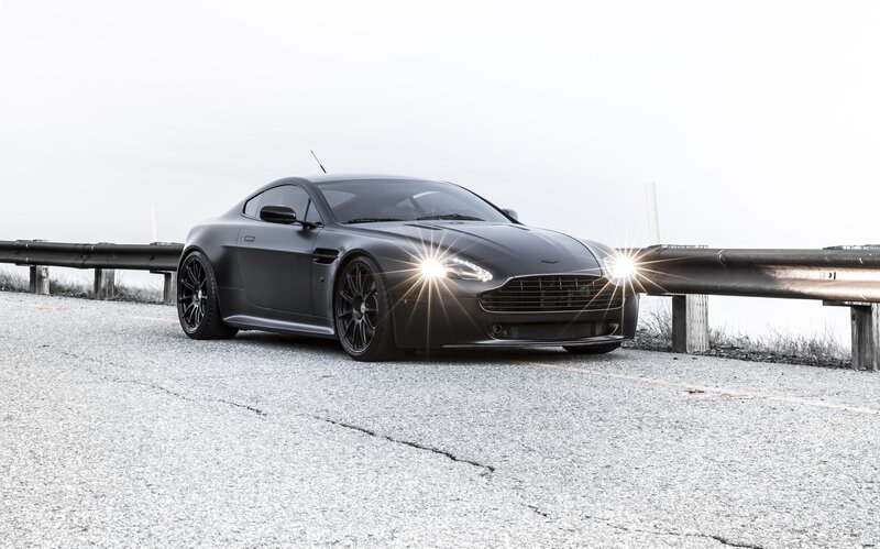 Matte black sports car on road