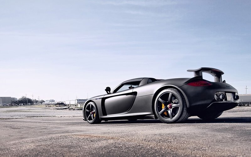 Matte black sports car on tarmac