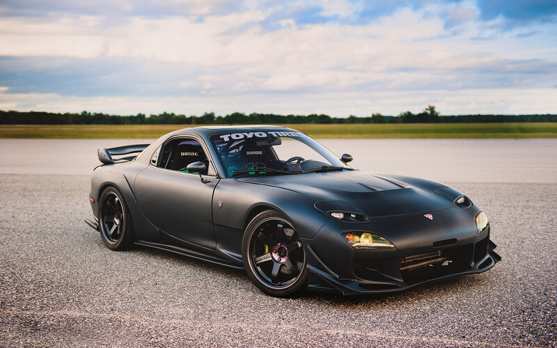 Matte black sports car on track