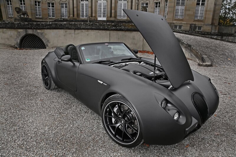 Matte black sports car with open hood