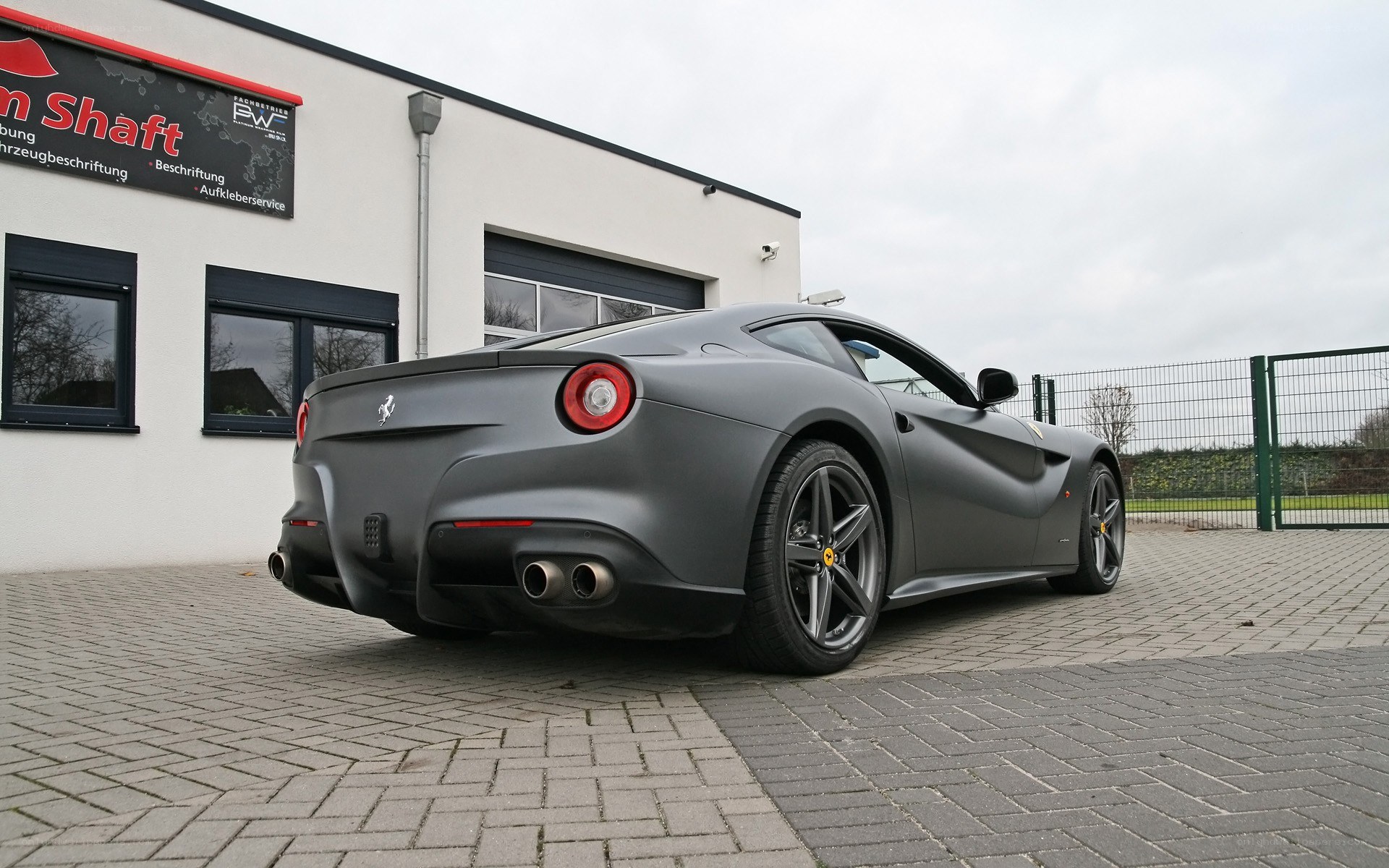 Matte gray Ferrari F12 parked outside