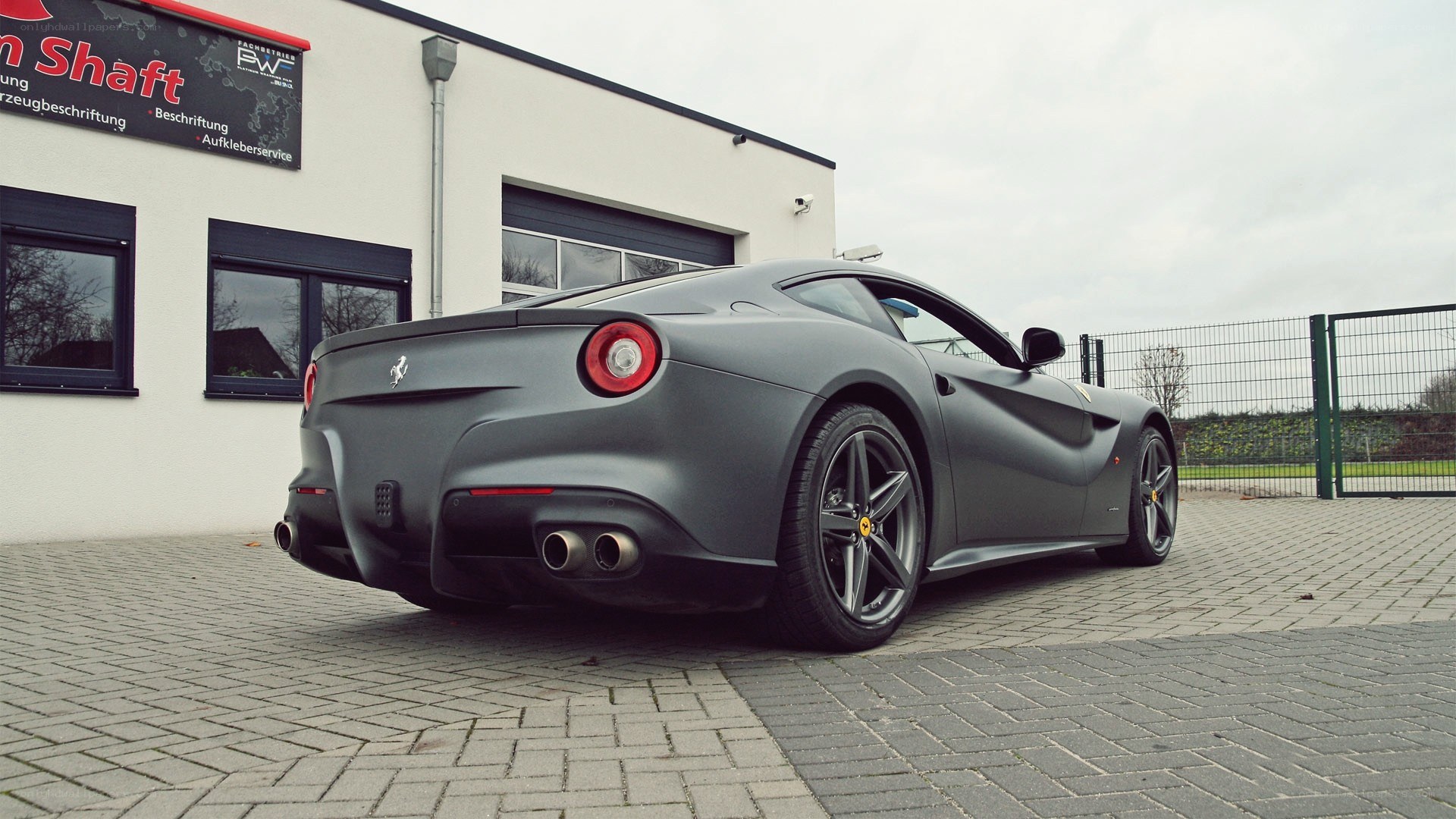 Matte gray Ferrari parked outside