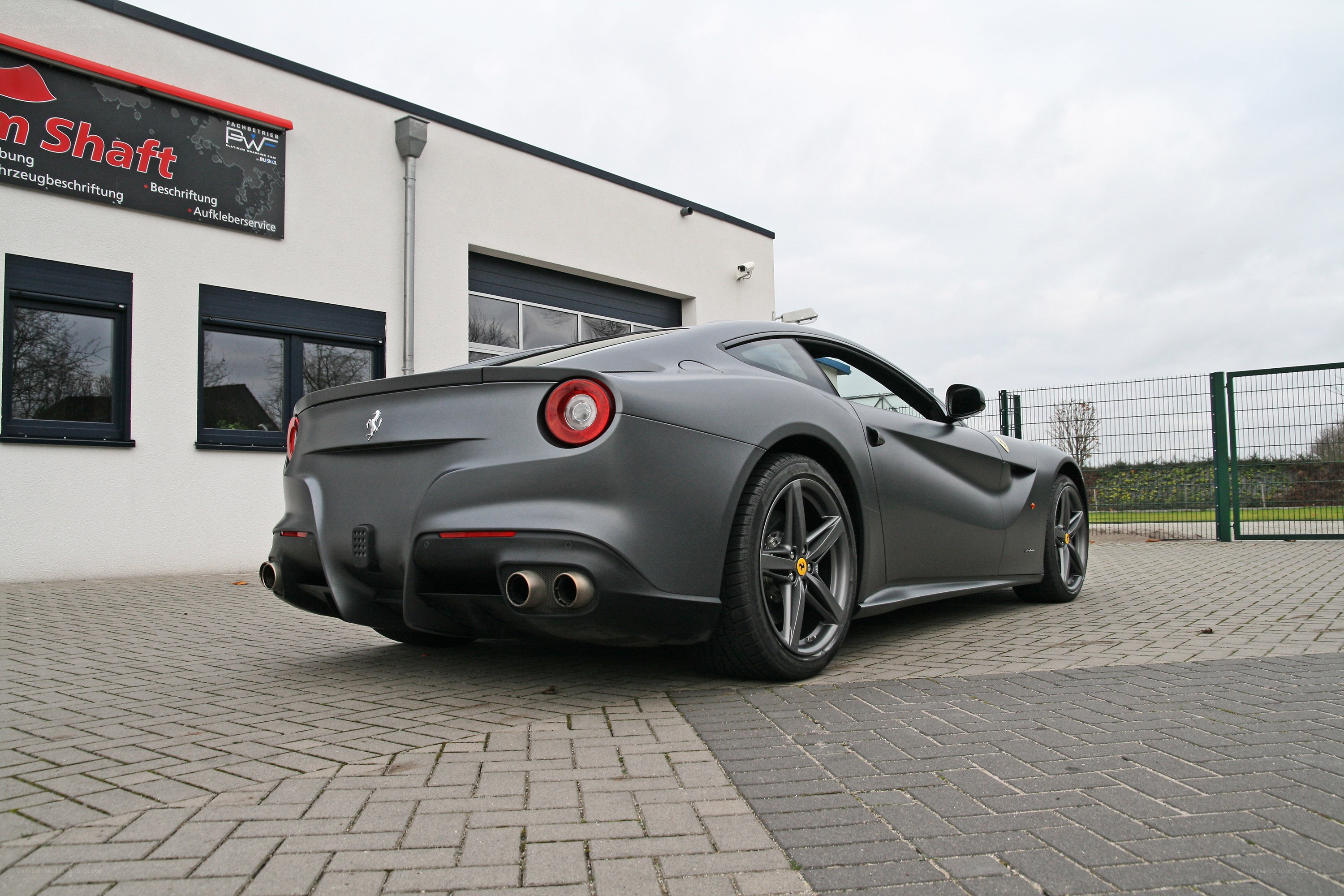 Matte gray Ferrari parked outside