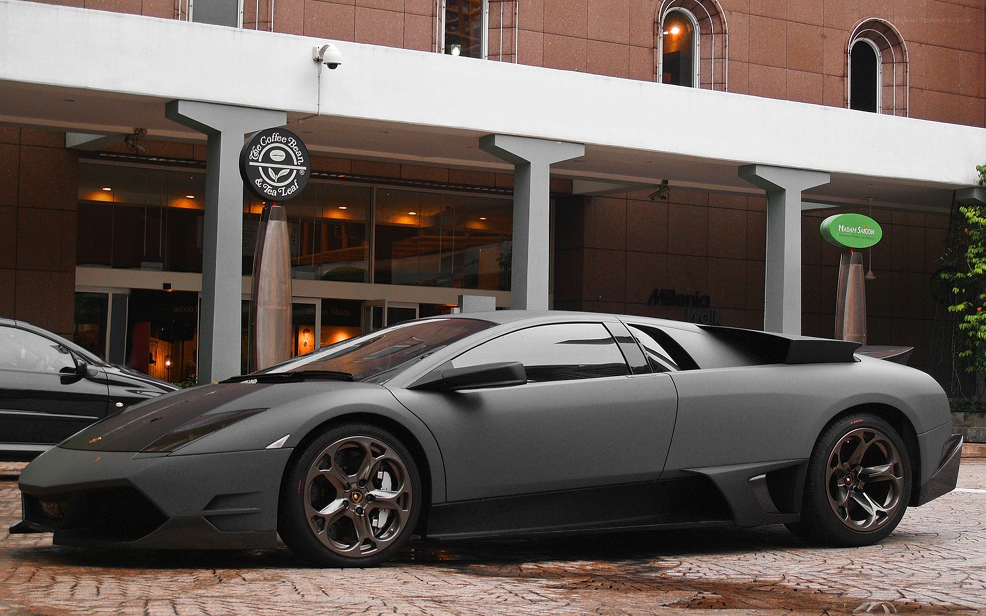 Matte gray Lamborghini parked outside