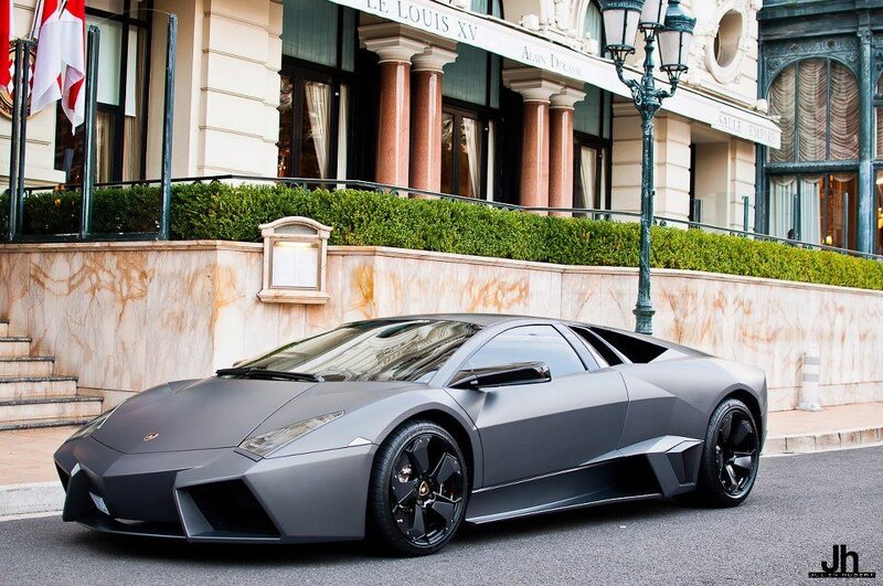 Matte gray Lamborghini parked outside hotel