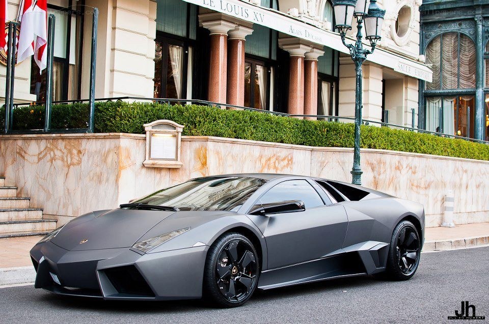 Matte gray Lamborghini parked outside hotel