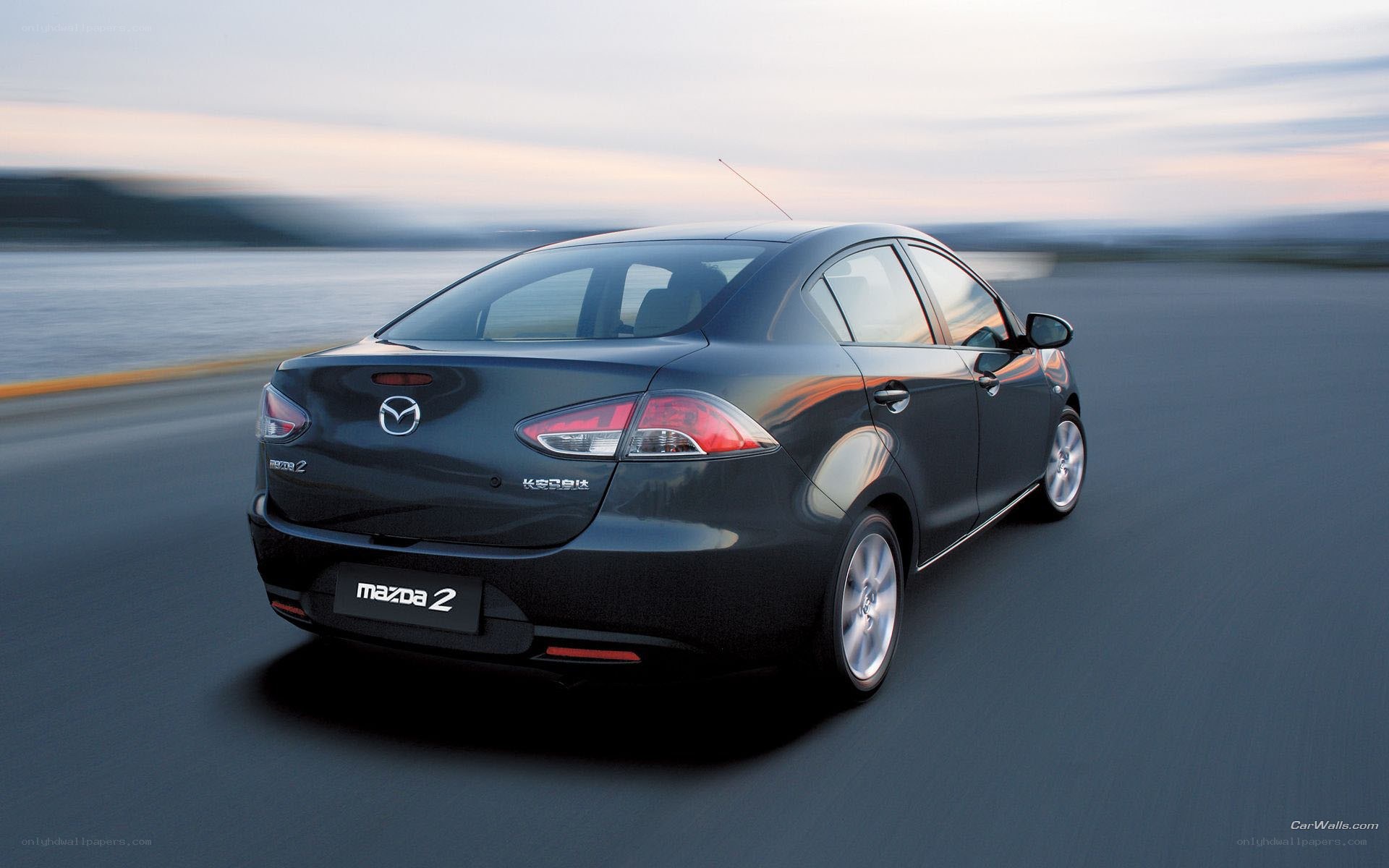 Mazda 2 driving on coastal road