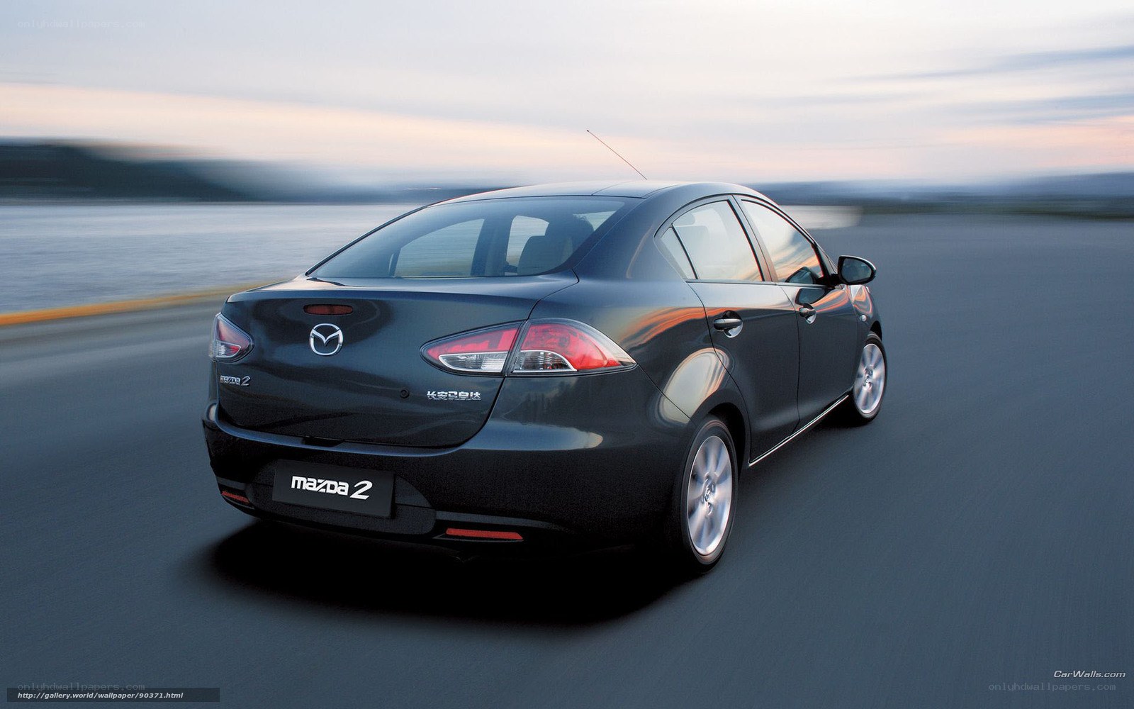 Mazda 2 driving on coastal road