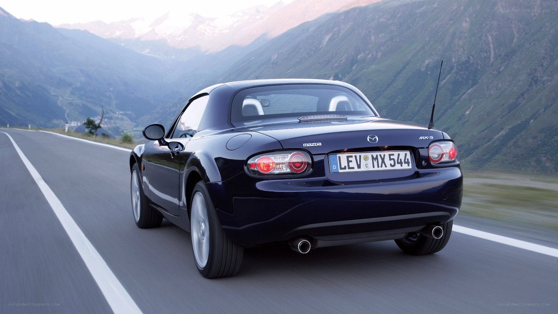 Mazda MX-5 driving on mountain road