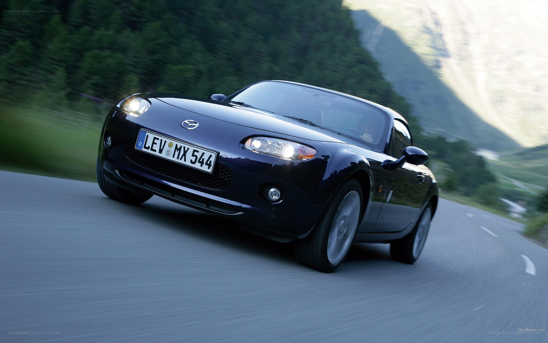 Mazda MX-5 driving on mountain road