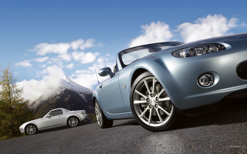 Mazda MX-5 sports cars on mountain road