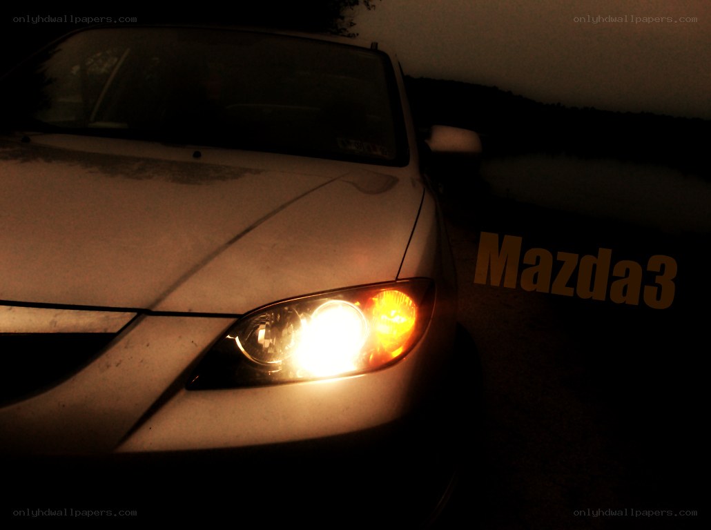 Mazda3 at night with headlights on