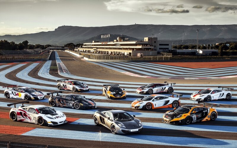 McLaren racing cars on track