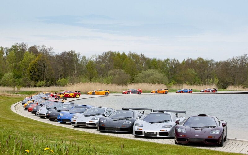 McLaren supercars by a lake