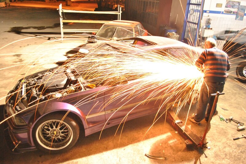Mechanic welding car parts