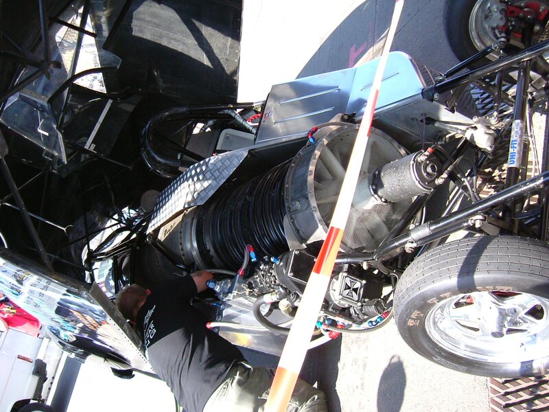 Mechanic working on race car engine