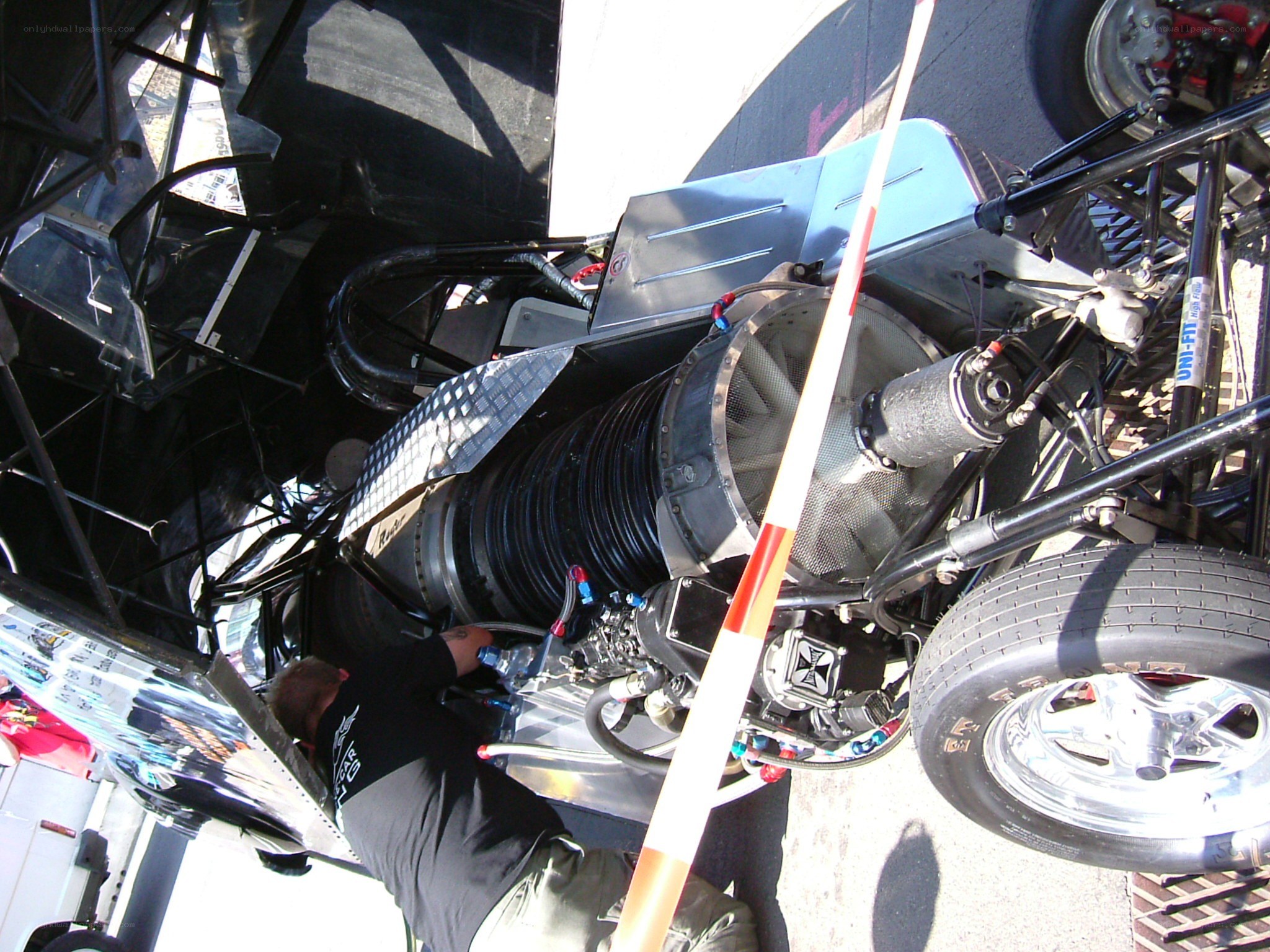 Mechanic working on race car engine