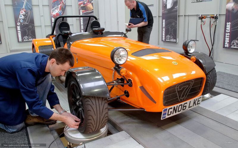 Mechanics working on a sports car