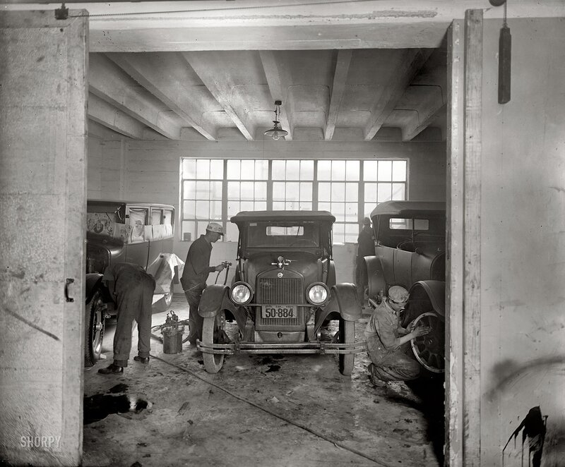 Mechanics working on vintage cars