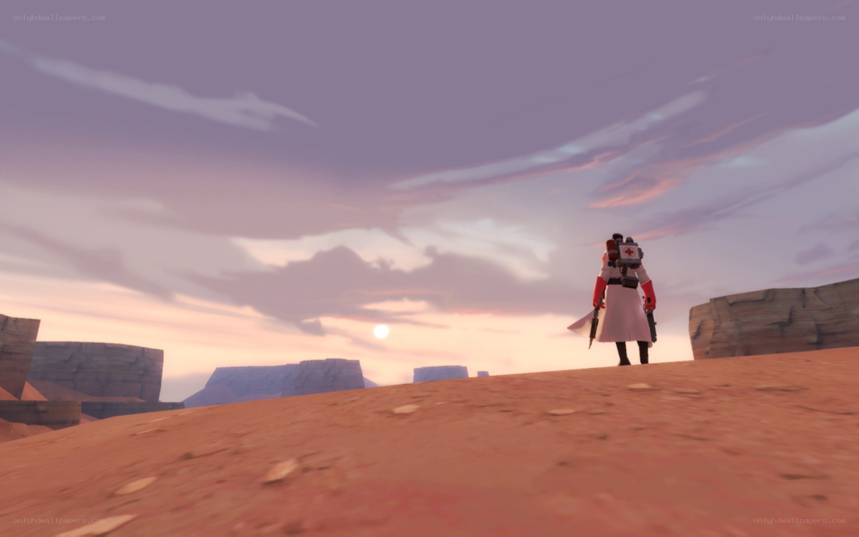 Medic in desert at sunset