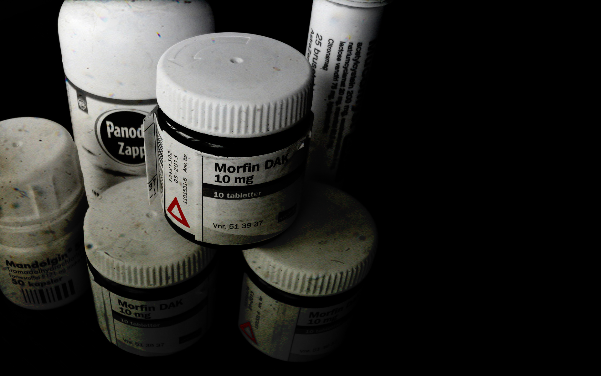 Medicine bottles on dark surface