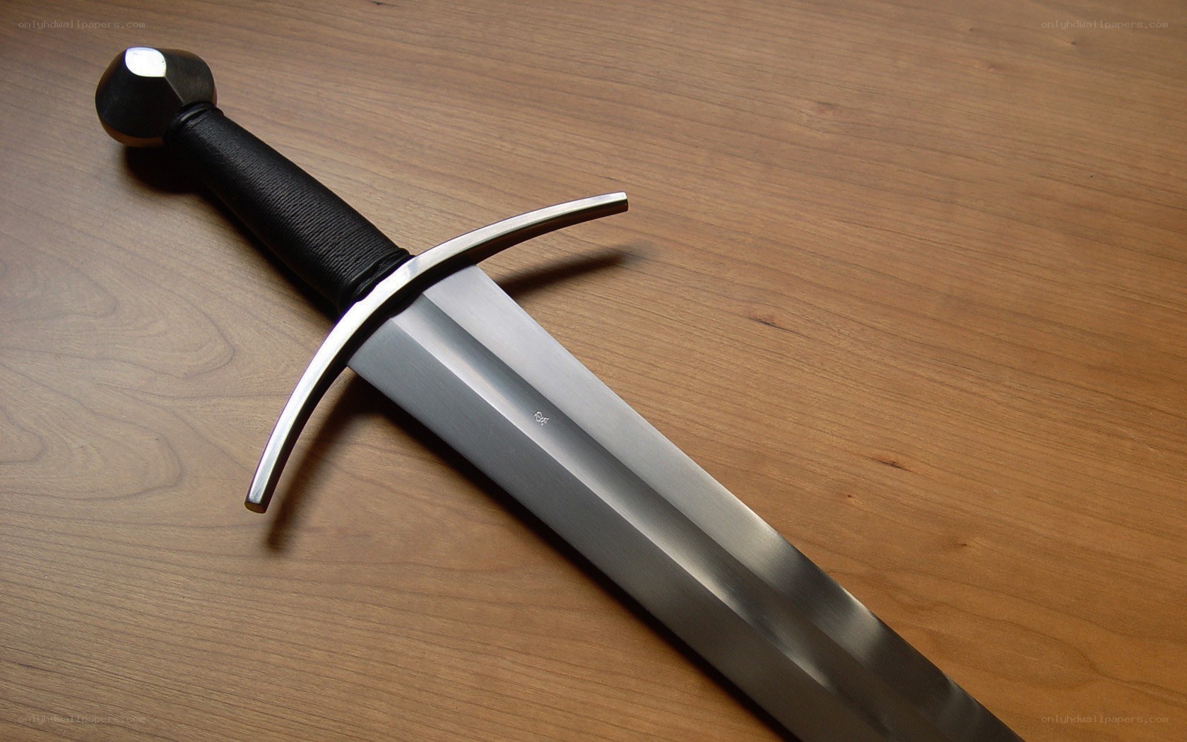 medieval sword on wooden surface