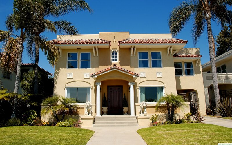 Mediterranean-style home with palm trees