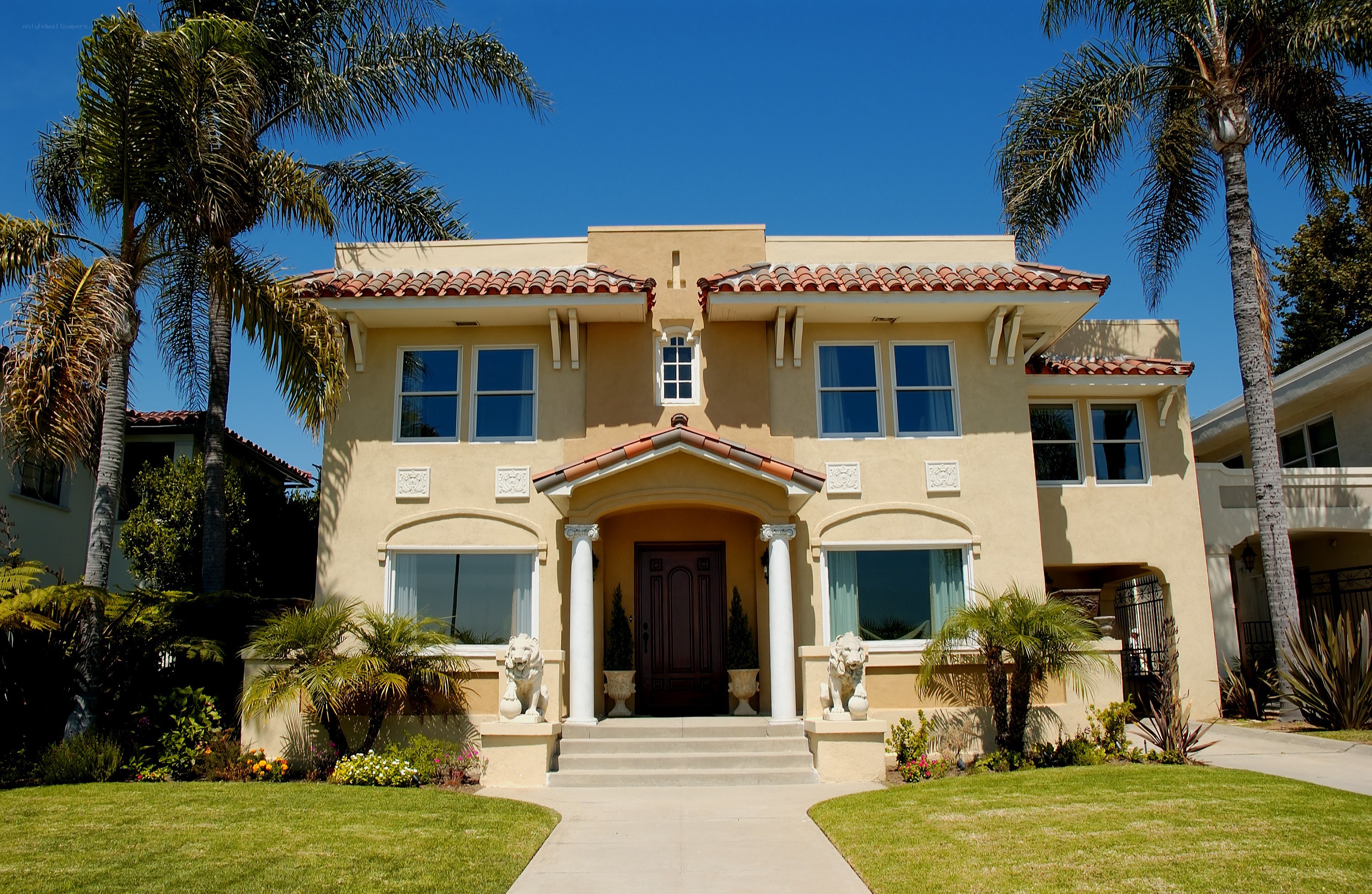 Mediterranean-style home with palm trees