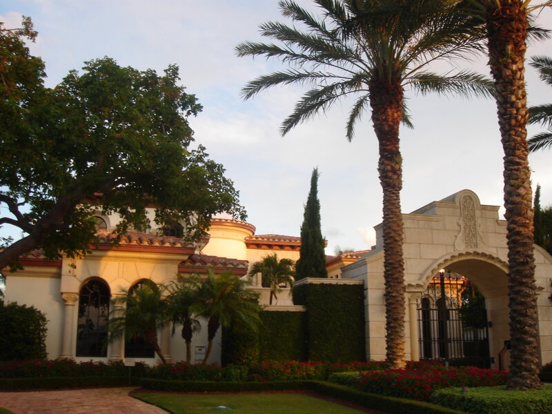 Mediterranean-style mansion with palm trees