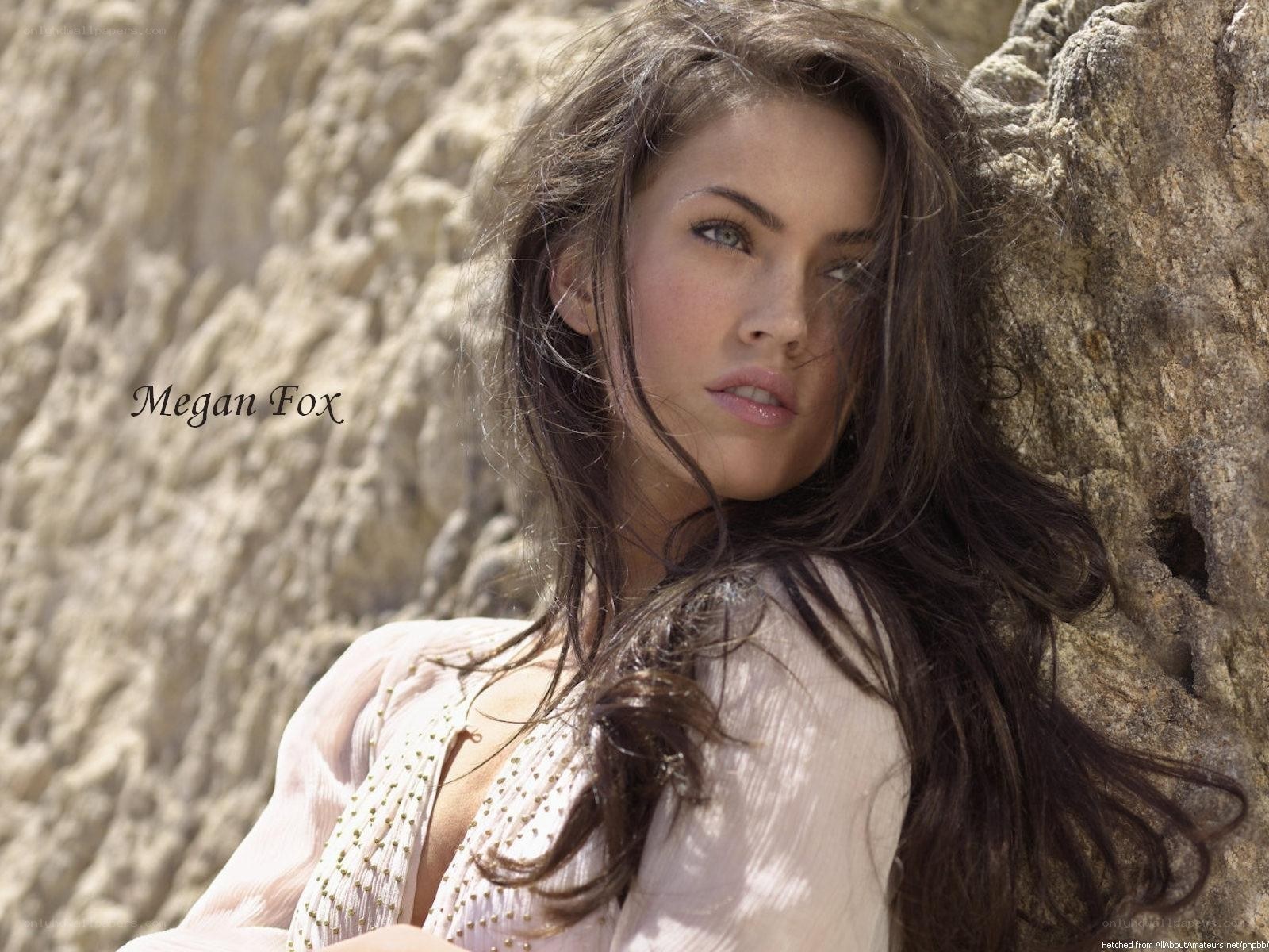 Megan Fox by rock wall
