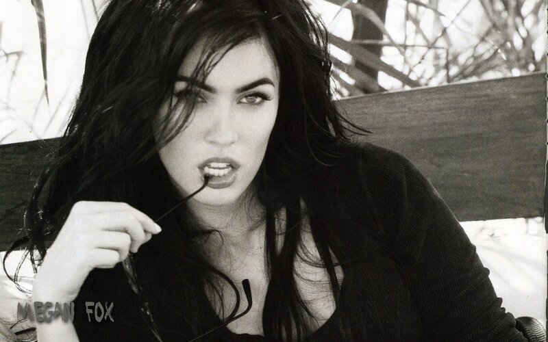 Megan Fox holding glasses