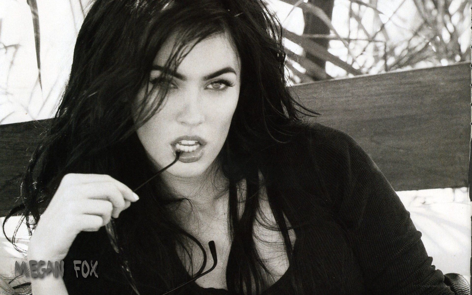 Megan Fox holding glasses