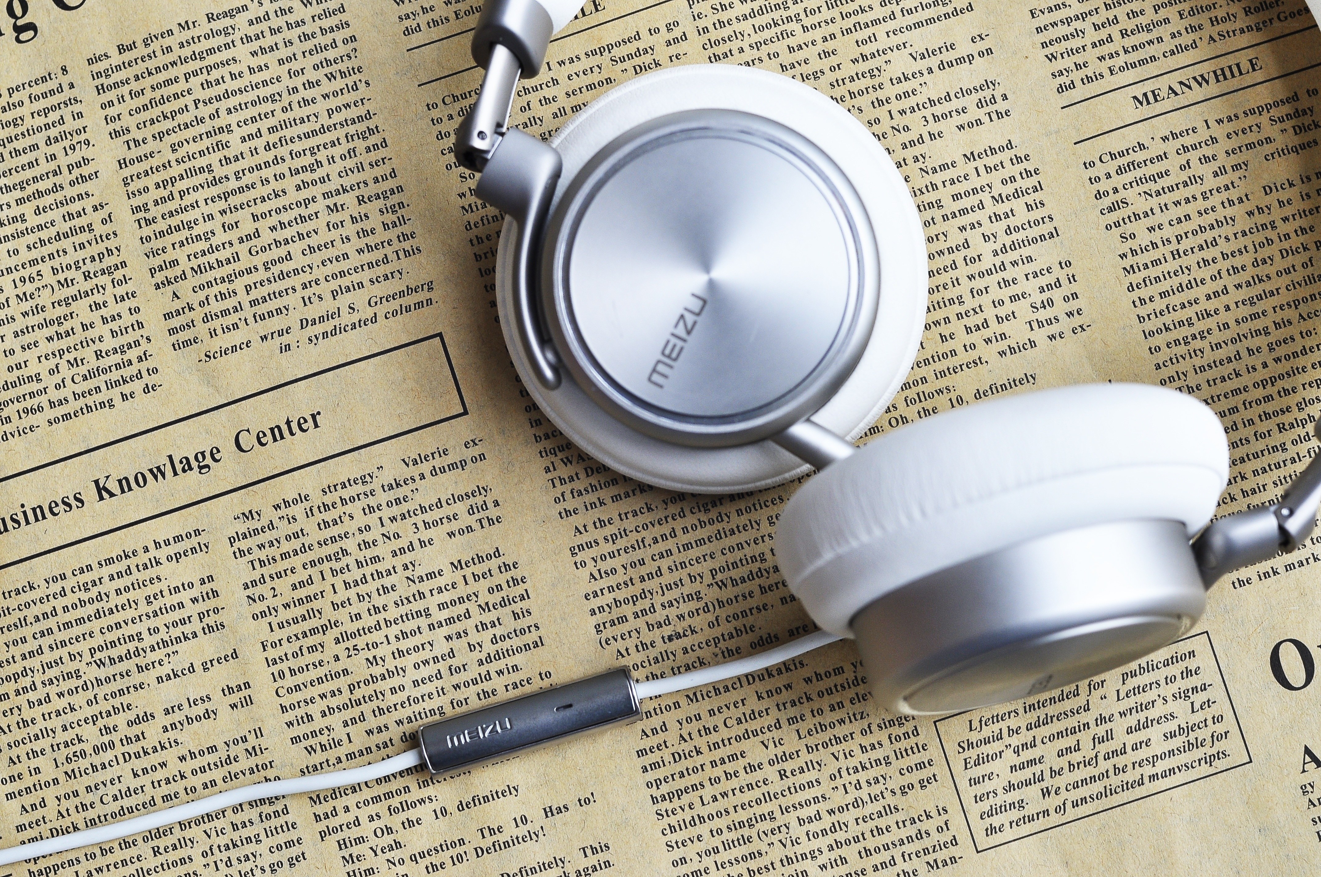 Meizu headphones on newspaper