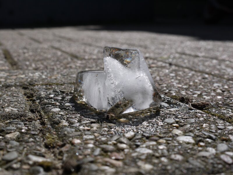 melting ice cube on pavement