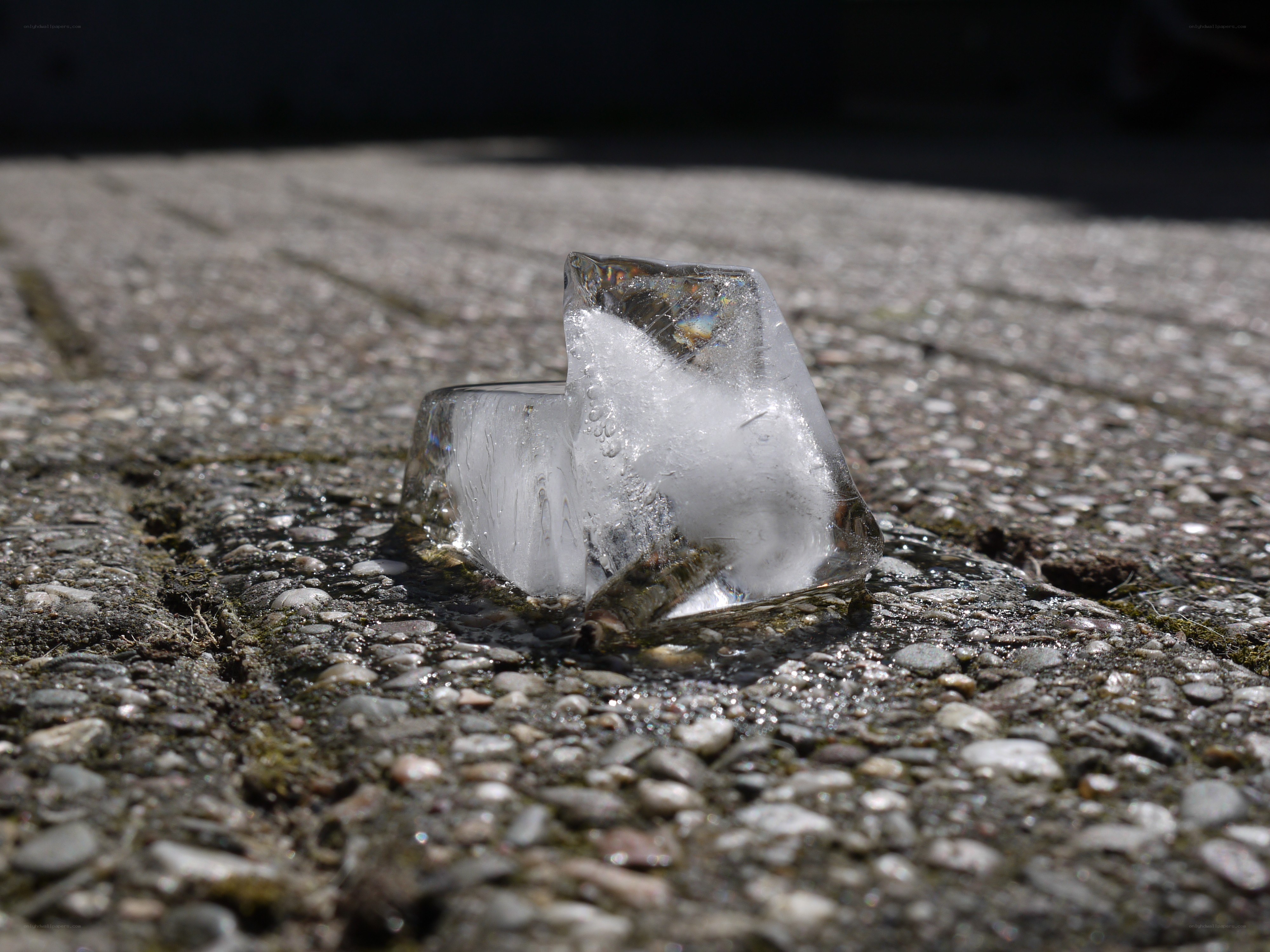 melting ice cube on pavement