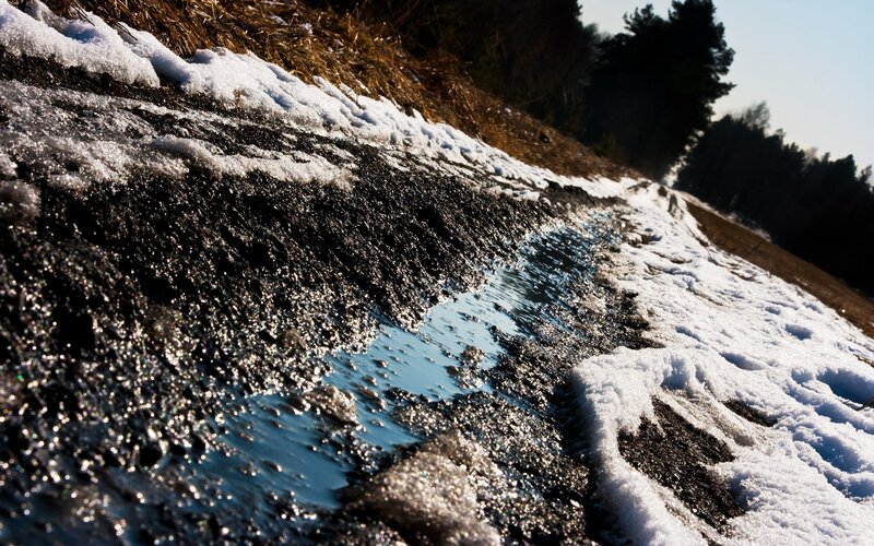 Melting snow on a forest path
