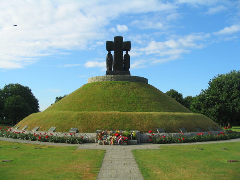 Memorial cross on a grassy mound
