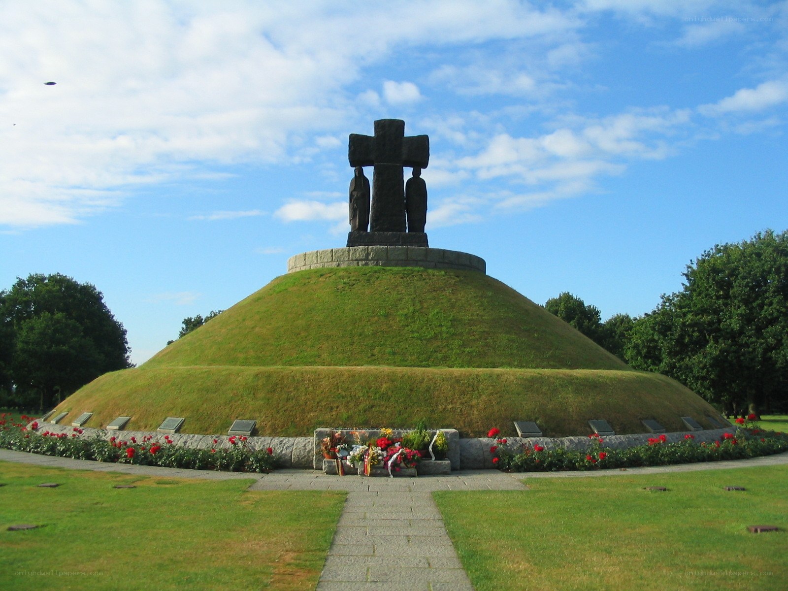 Memorial cross on a grassy mound