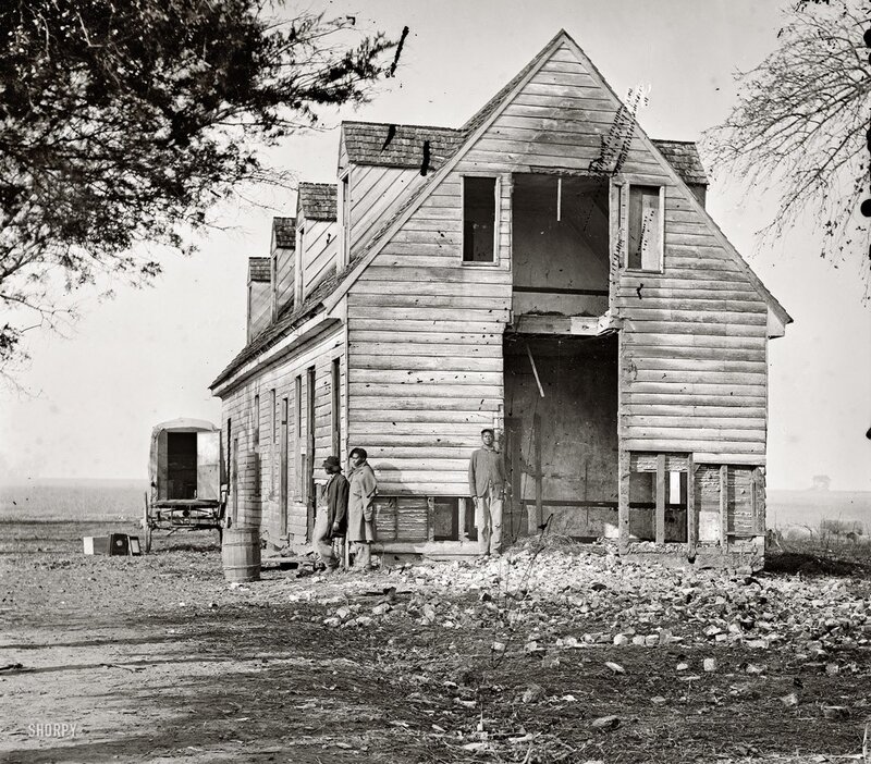 Men at a damaged house